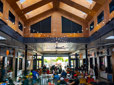 A crowd of people enjoy ethnic dishes inside the Rockwood Market Hall dining area.